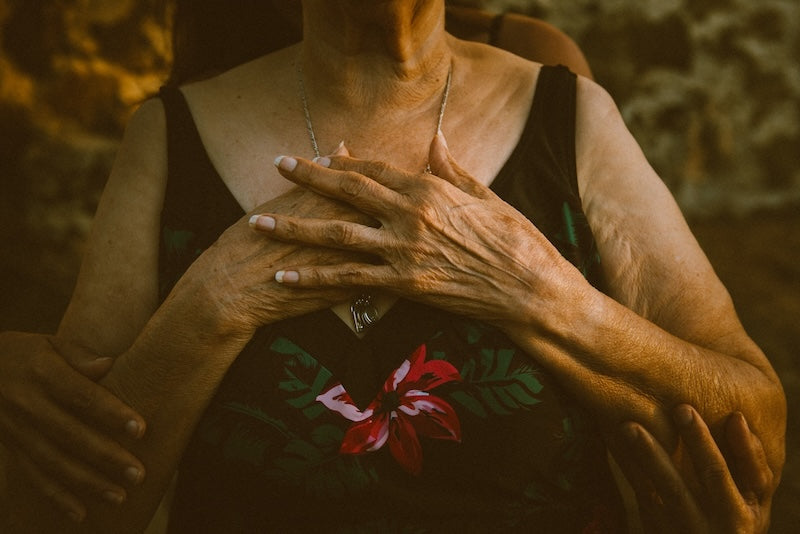 A close-up of a TONGUE TIED can in hand against a warm-lit backdrop