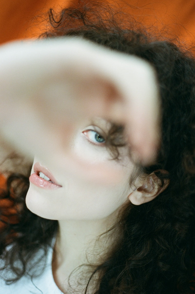 Two people in close conversation, soft golden light, direct gaze